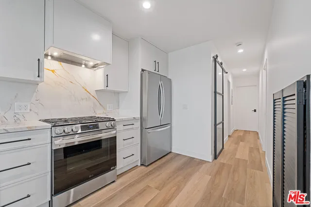 a kitchen with a stove and a refrigerator