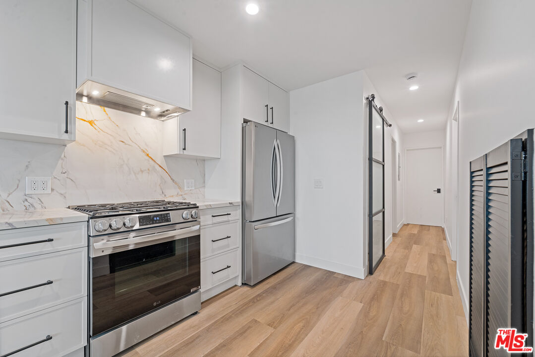 3305 Ocean Front Walk, Unit 1 & 2 Marina del Rey, CA 90292 - Photo 6 of 44 a kitchen with a stove and a refrigerator