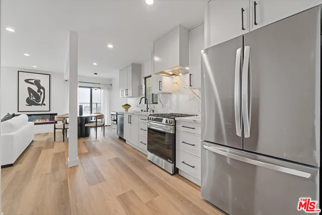a kitchen with stainless steel appliances a refrigerator sink and stove