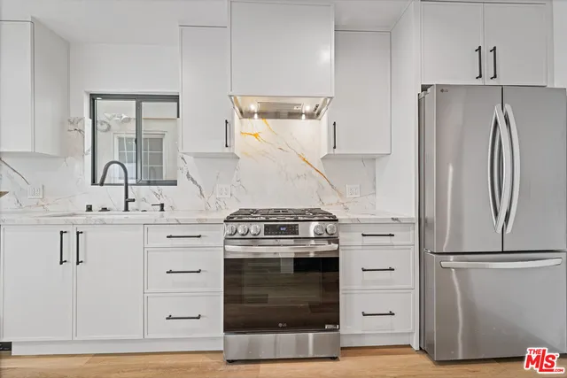 a kitchen with a stove and a refrigerator