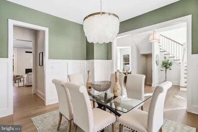 a dining room with furniture and wooden floor