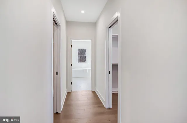 a view of a hallway with wooden floor