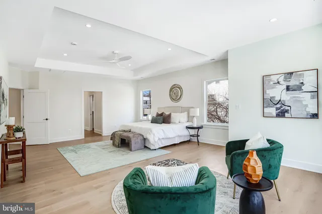 a bedroom with furniture and a large window