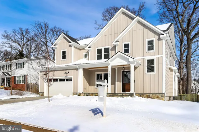 a view of a white house with a large windows and large trees