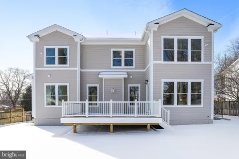 a view of a house with a balcony and wooden fence