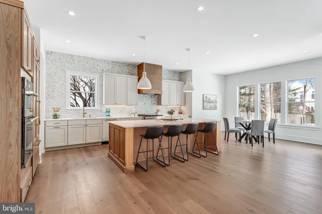 a kitchen with a table chairs sink and cabinets