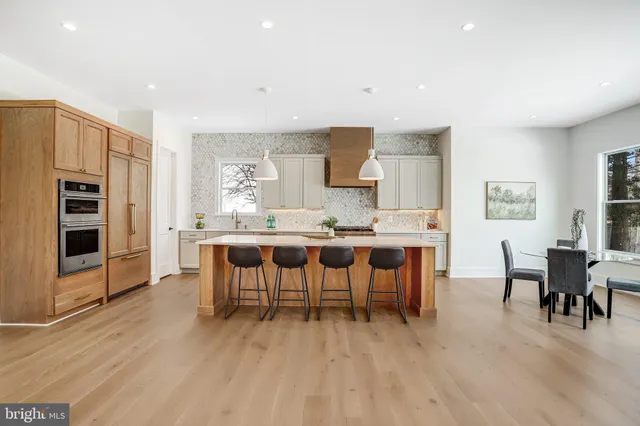 a dining room with furniture and wooden floor