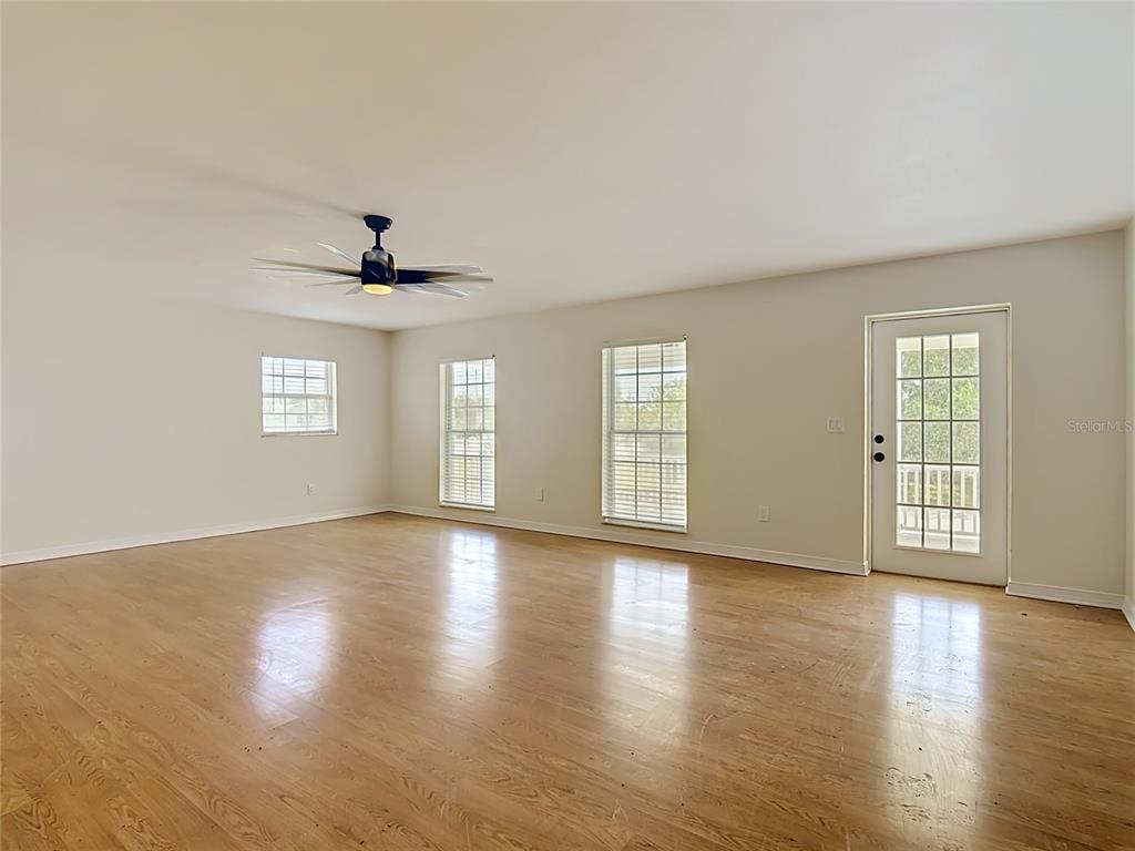 7925 Lake Mabel Loop Road Lake Wales, FL 33898 - Photo 25 of 97 a view of an empty room with wooden floor and a window