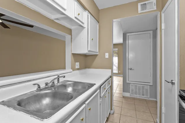 a kitchen with a sink cabinets and entryway