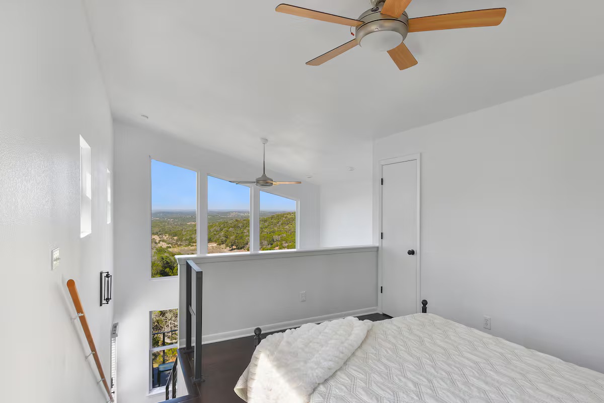 620 Windy Hills Road Dripping Springs, TX 78620 - Photo 20 of 30 Home 2 - Bedroom featuring a ceiling fan and wood finished floors