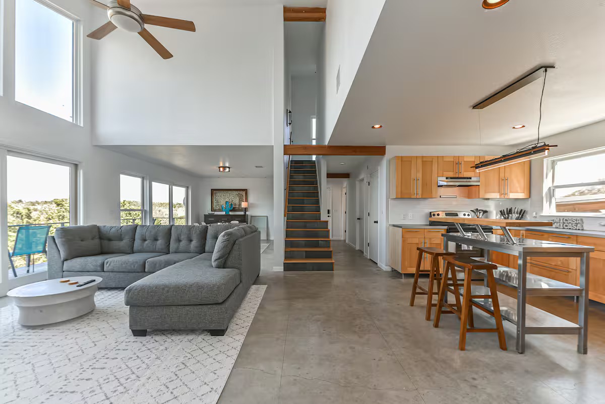 620 Windy Hills Road Dripping Springs, TX 78620 - Photo 8 of 30 Home 1 - Living room featuring a ceiling fan, concrete floors, a high ceiling, and recessed lighting.