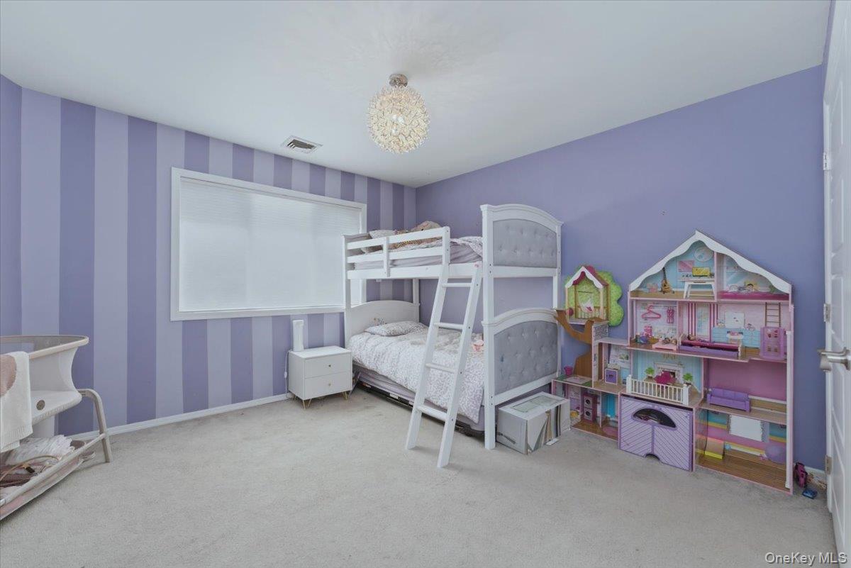 151 Wanser Avenue Inwood, NY 11096 - Photo 11 of 19 a bed room with a bed and a window