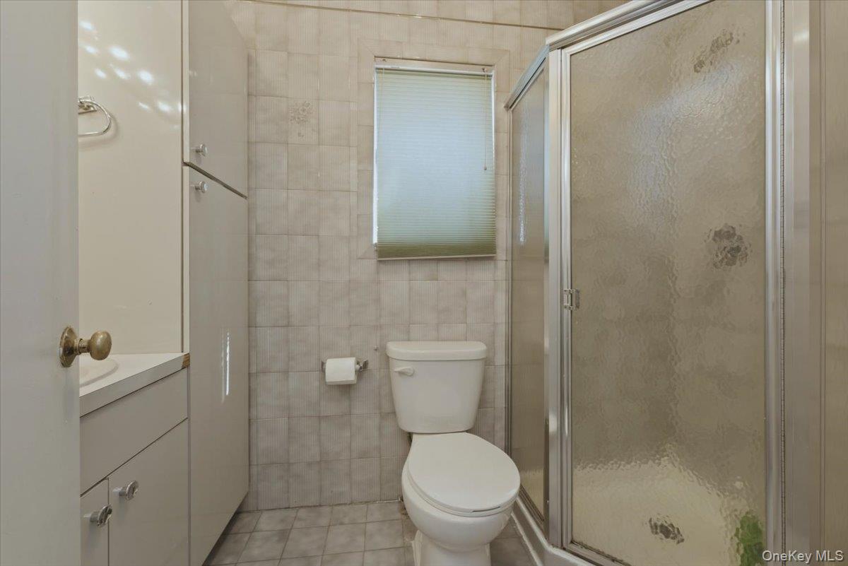 151 Wanser Avenue Inwood, NY 11096 - Photo 14 of 19 a bathroom with a toilet and a shower
