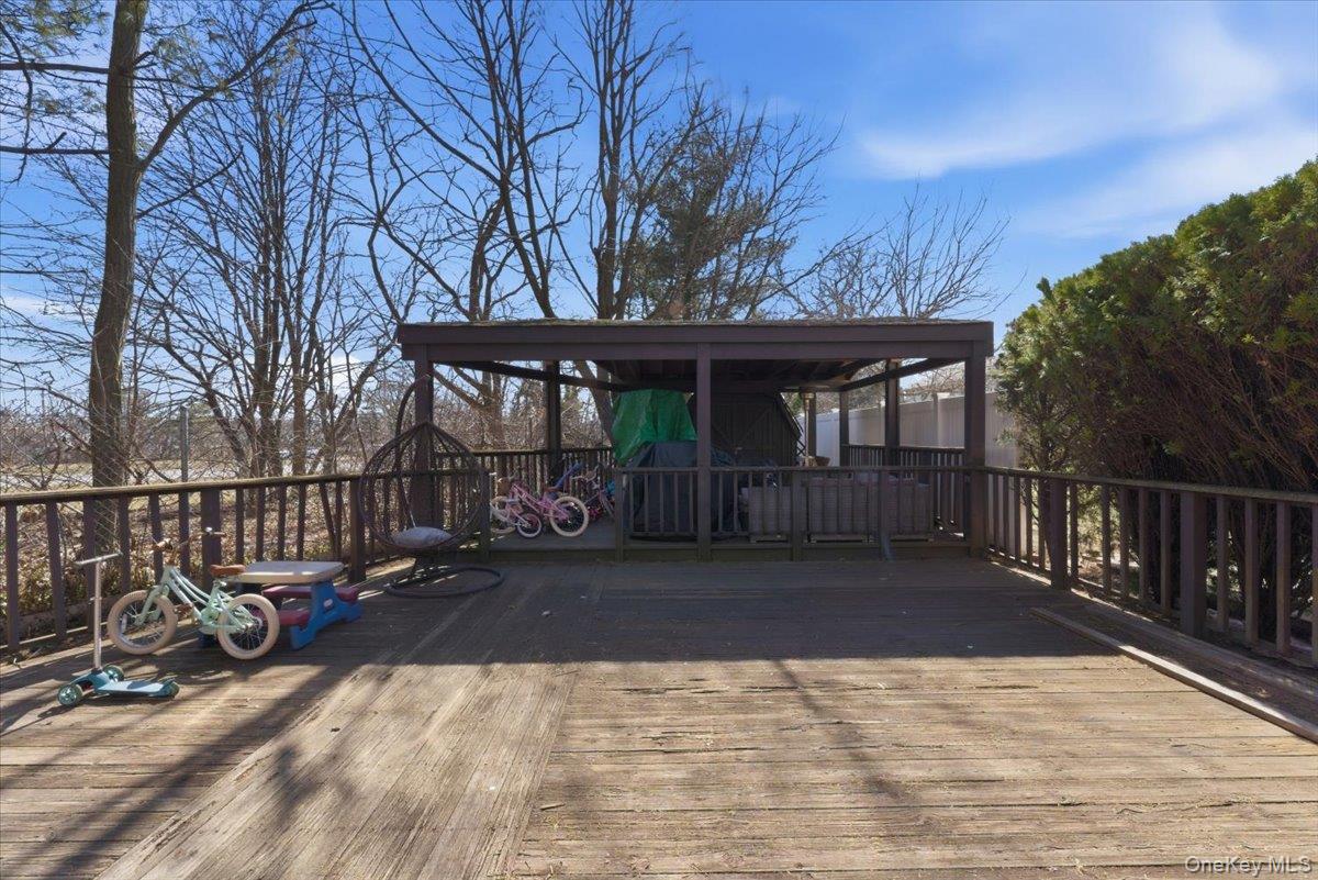 151 Wanser Avenue Inwood, NY 11096 - Photo 18 of 19 a view of a house with a large window and wooden fence