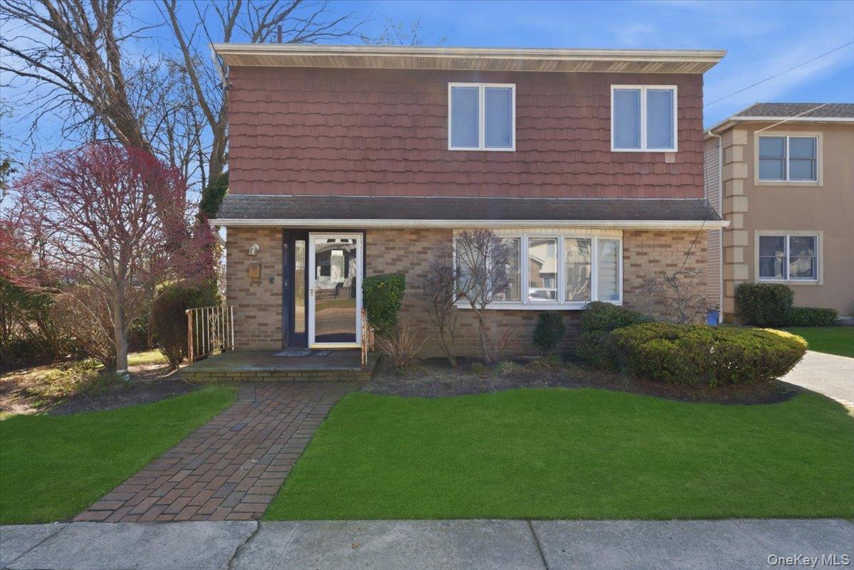 151 Wanser Avenue Inwood, NY 11096 - Photo 19 of 19 a brick building with a yard in front of it