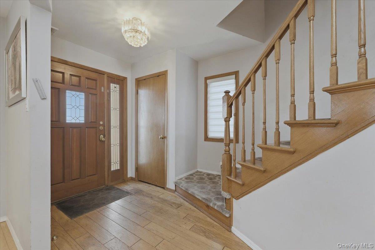 151 Wanser Avenue Inwood, NY 11096 - Photo 2 of 19 a view of a hallway with wooden floor and staircase