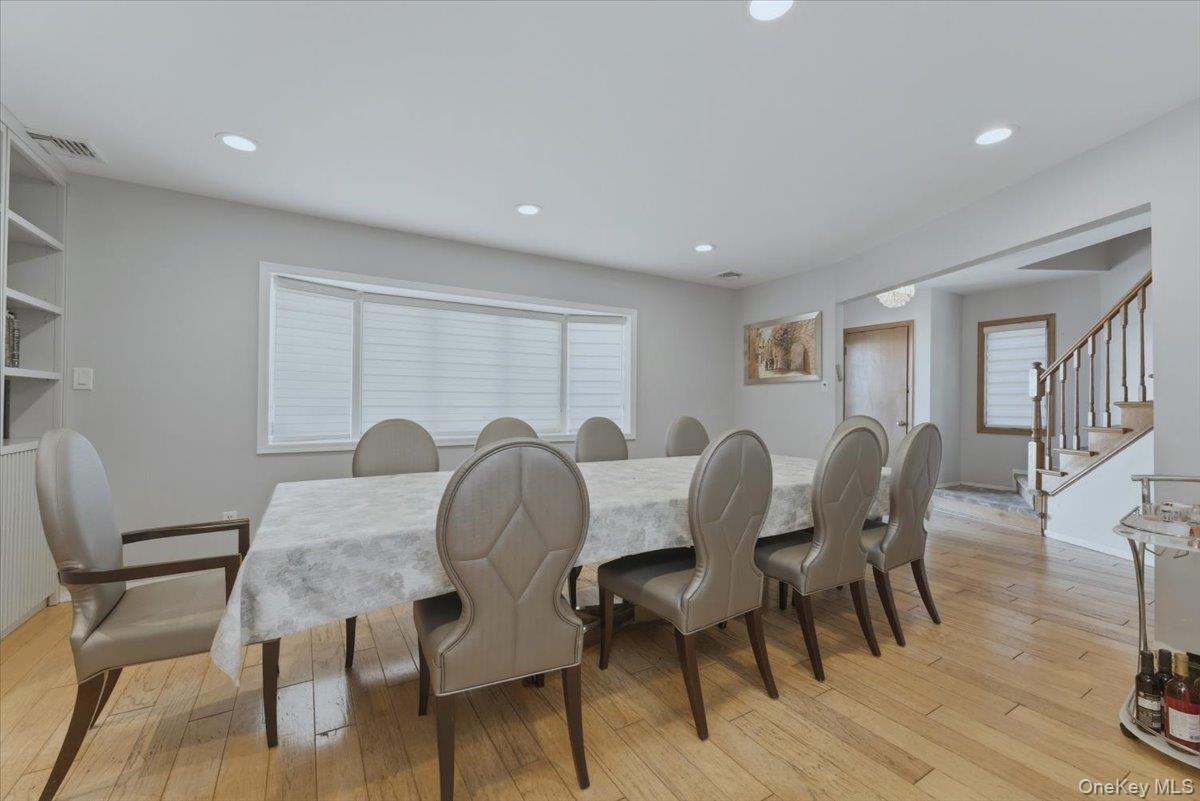 151 Wanser Avenue Inwood, NY 11096 - Photo 3 of 19 a view of a dining room with furniture and wooden floor