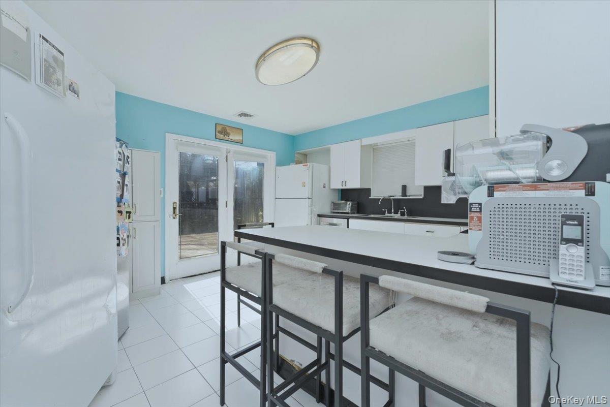 151 Wanser Avenue Inwood, NY 11096 - Photo 7 of 19 a kitchen with stainless steel appliances granite countertop a sink and cabinets