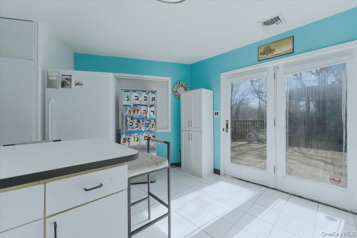 151 Wanser Avenue Inwood, NY 11096 - Photo 9 of 19 a room that has a painting on the wall and a large mirror