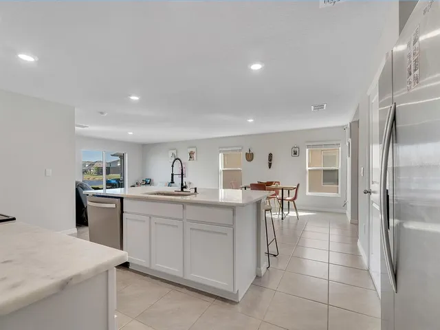 a kitchen that has a lot of cabinets in it and appliances