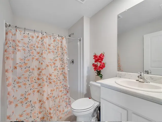a bathroom with a sink toilet and a shower