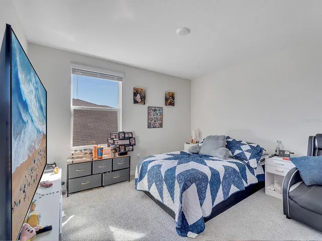 a bedroom with a bed and a couch