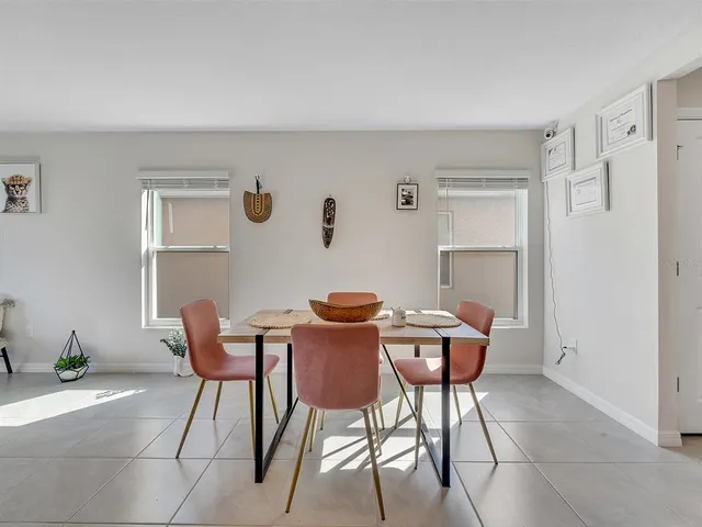 a dining room with furniture and window