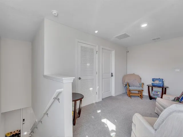 a living room with furniture and a lamp