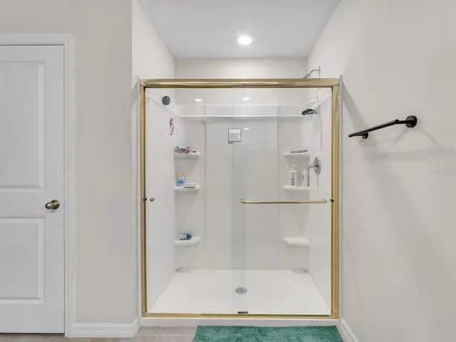 a bathroom with a glass shower door