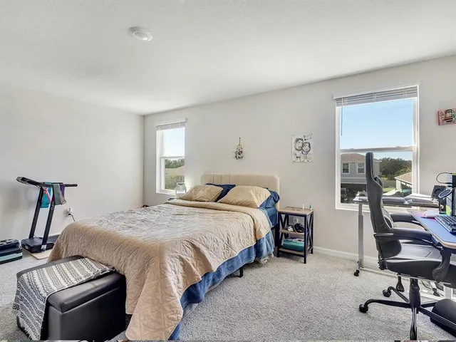 a bedroom with bed and a window