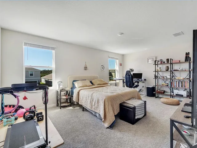 a bedroom with bed and a couch