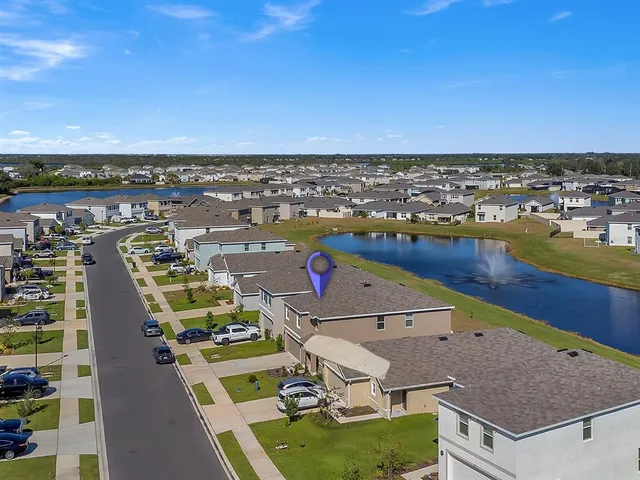 an aerial view of residential houses with outdoor space