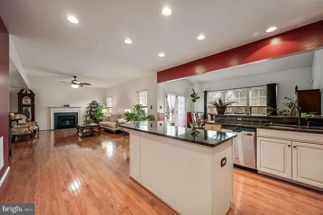a kitchen with sink cabinets and wooden floor