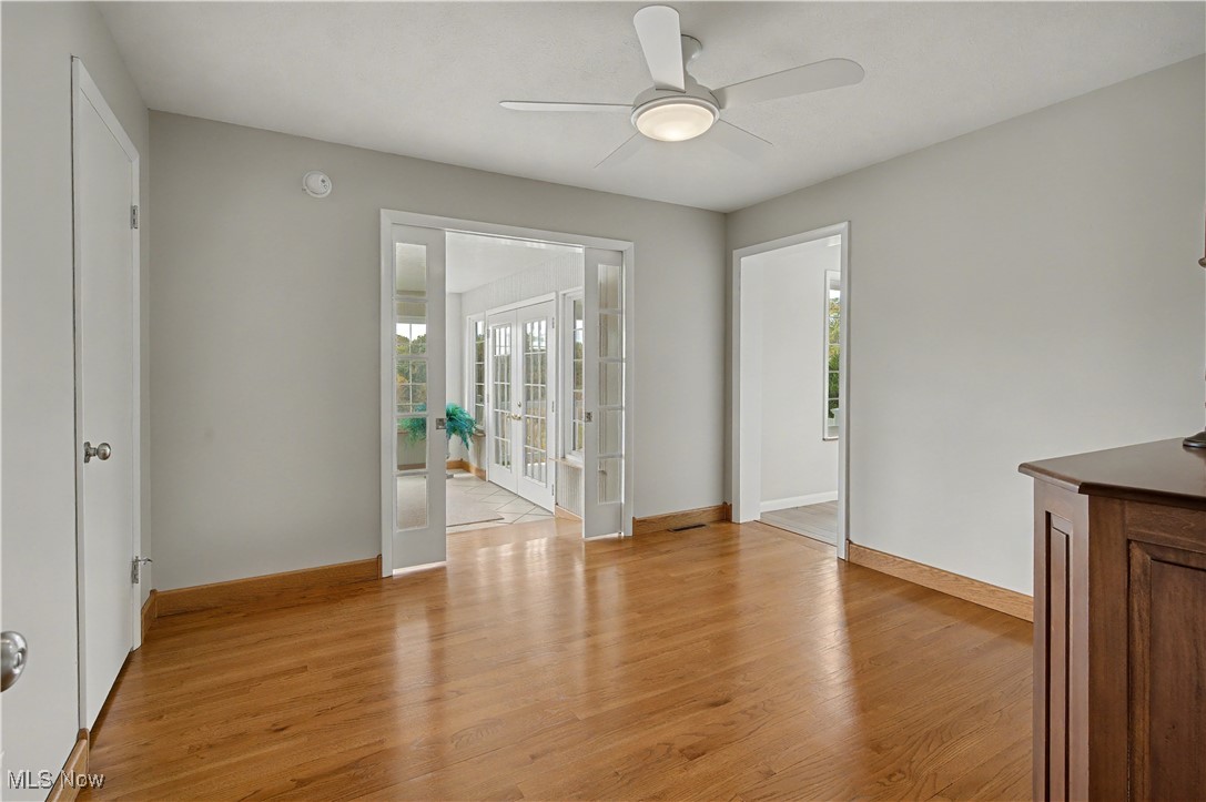 913 Rost Road Walker, WV 26180 - Photo 24 of 48 Unfurnished living room featuring french doors, light wood finished floors, healthy amount of natural light, and ceiling fan