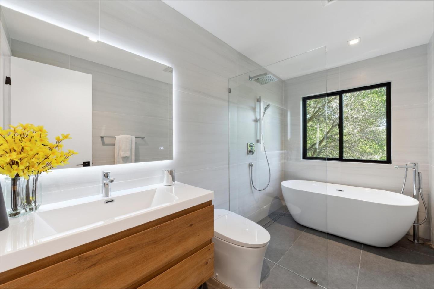 2620 Summit Drive Burlingame, CA 94010 - Photo 38 of 84 a bathroom with a sink a toilet a tub and a large mirror