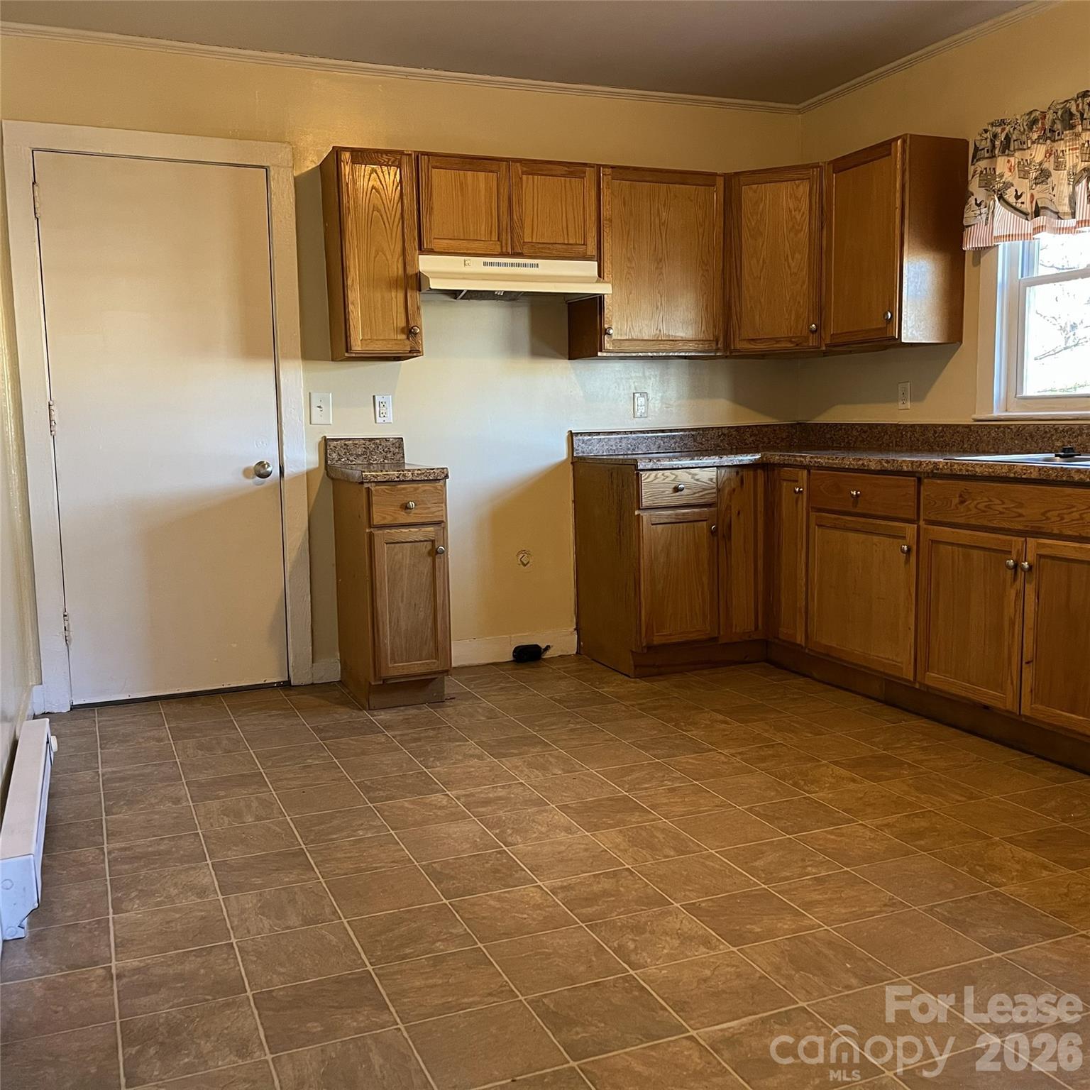 2621 Dr Carver Road Charlotte, NC 28208 - Photo 3 of 14 a kitchen with a stove a sink and cabinets