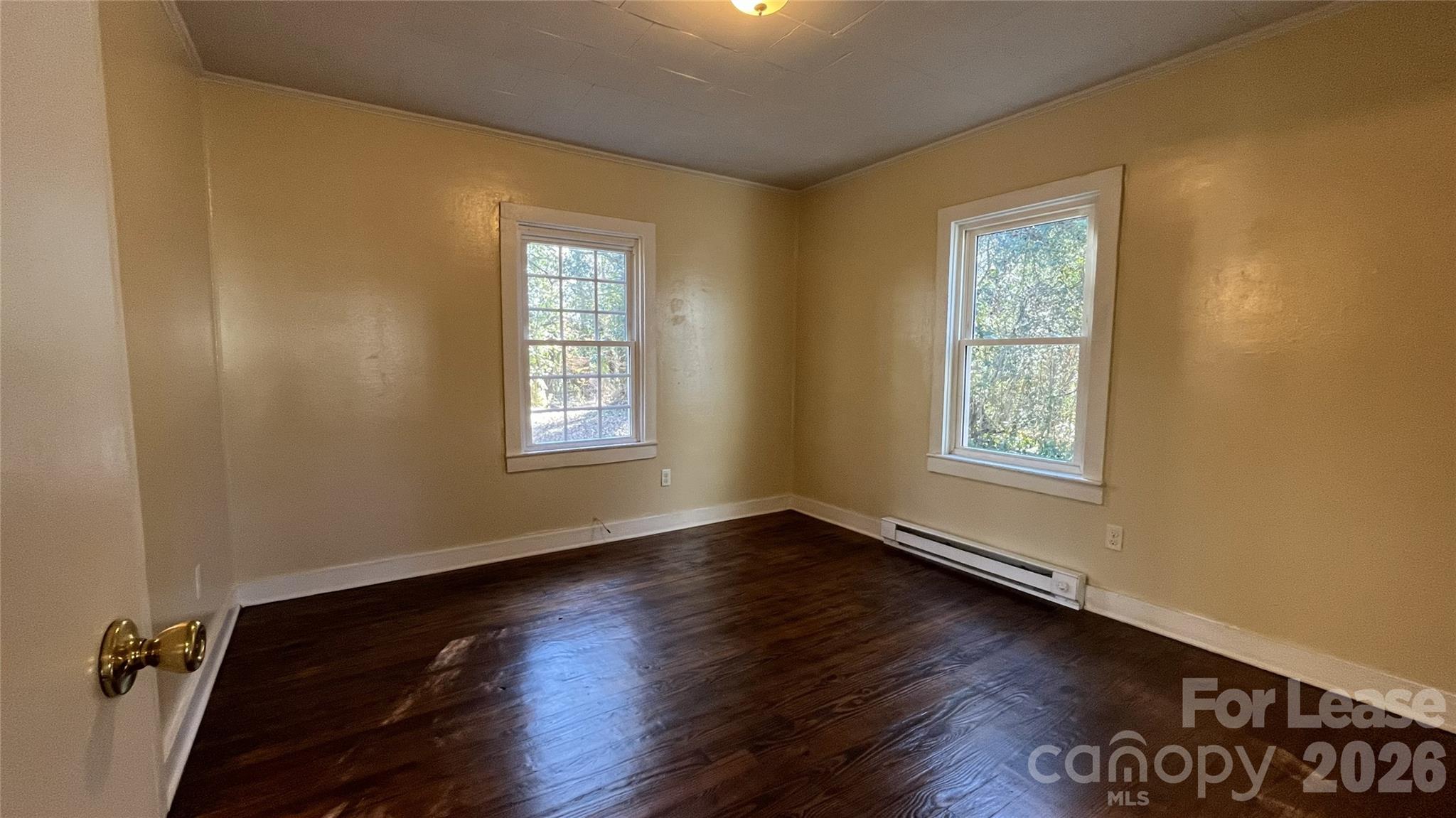 2621 Dr Carver Road Charlotte, NC 28208 - Photo 9 of 14 a view of an empty room with wooden floor and a window