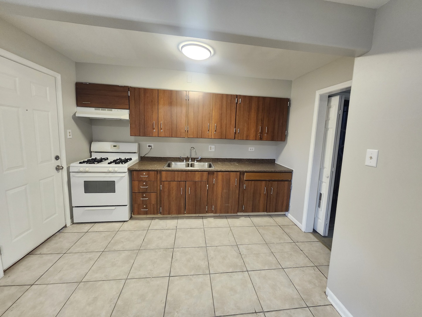 4807 South Wabash Avenue, Unit 2 Chicago, IL 60615 - Photo 5 of 7 a kitchen with stainless steel appliances a stove a microwave and a refrigerator