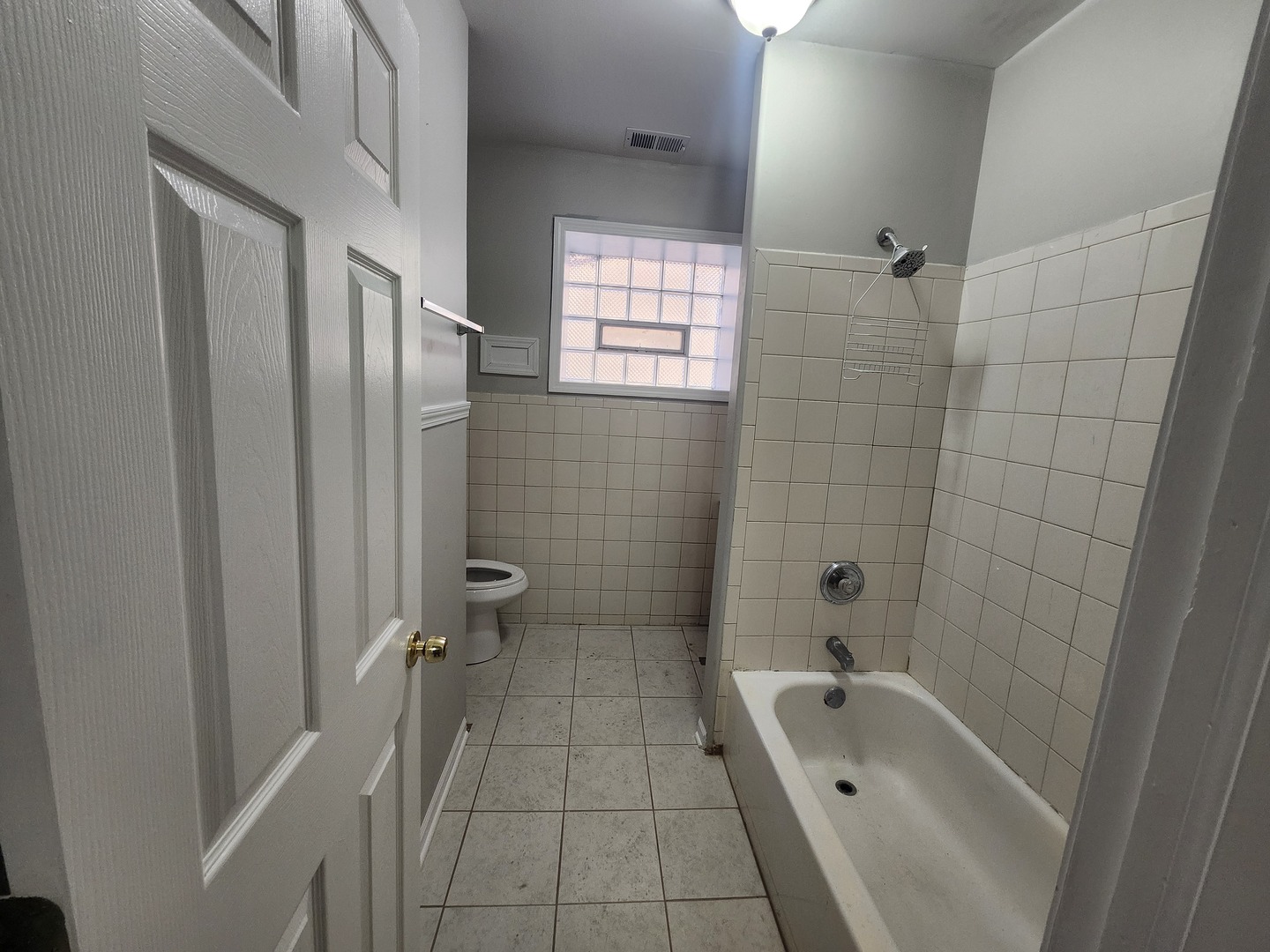 4807 South Wabash Avenue, Unit 2 Chicago, IL 60615 - Photo 7 of 7 a bathroom with a tub a sink a window and a shower