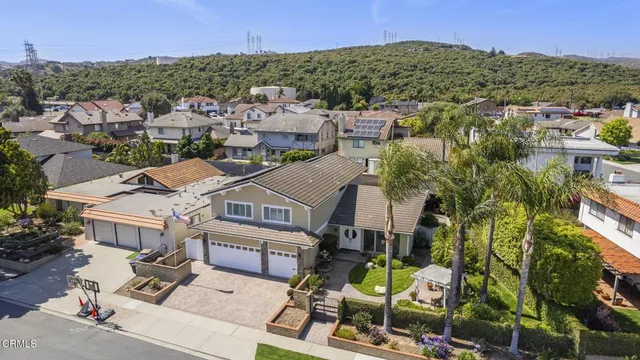 an aerial view of residential houses with outdoor space and parking