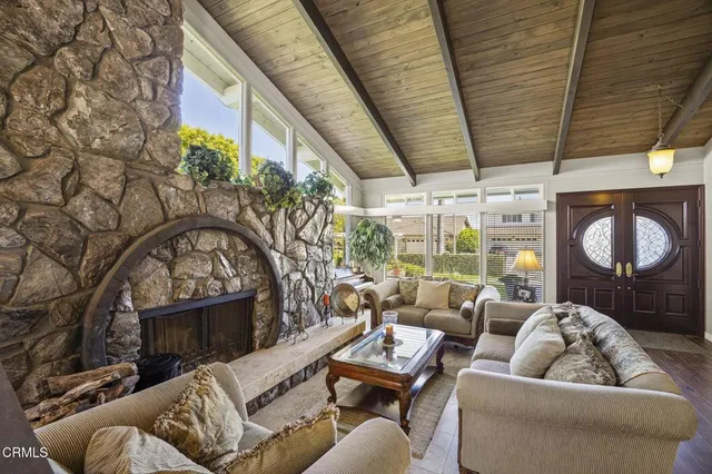 a living room with furniture a flat screen tv and a window