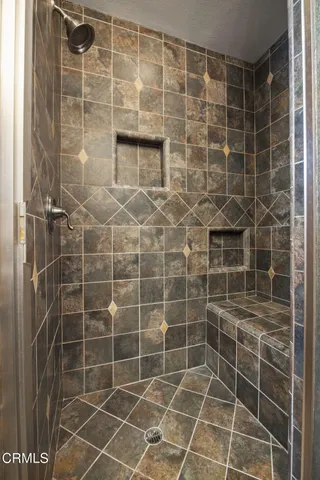 a outdoor kitchen with stainless steel appliances granite countertop a sink and a white cabinets