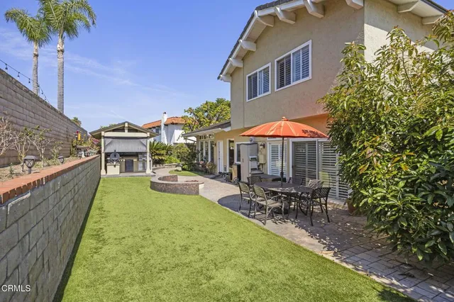 an aerial view of residential houses with outdoor space and mountain view