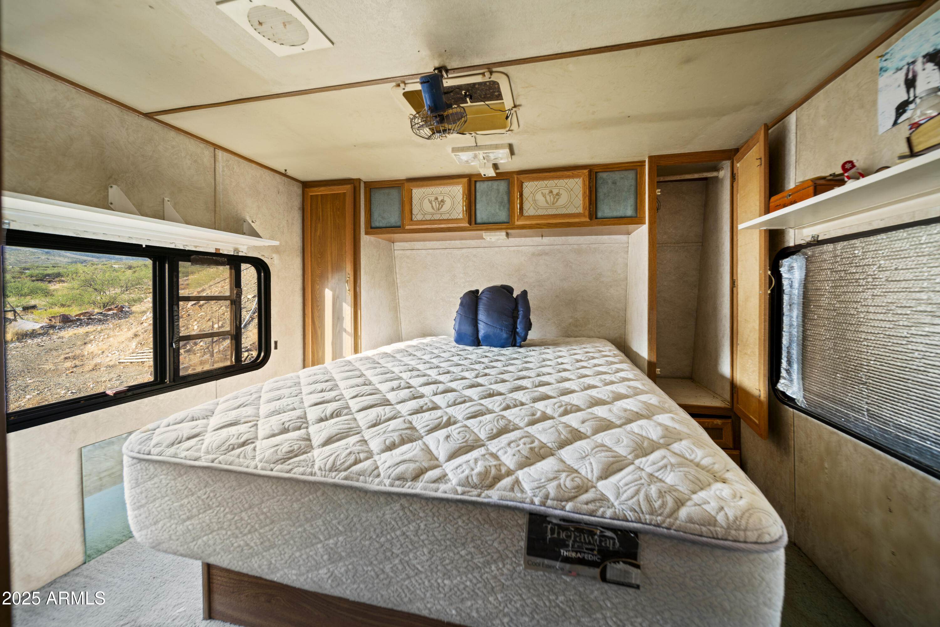 25795 South Old Stage Road Congress, AZ 85332 - Photo 14 of 30 a bed sitting in a bedroom next to a window