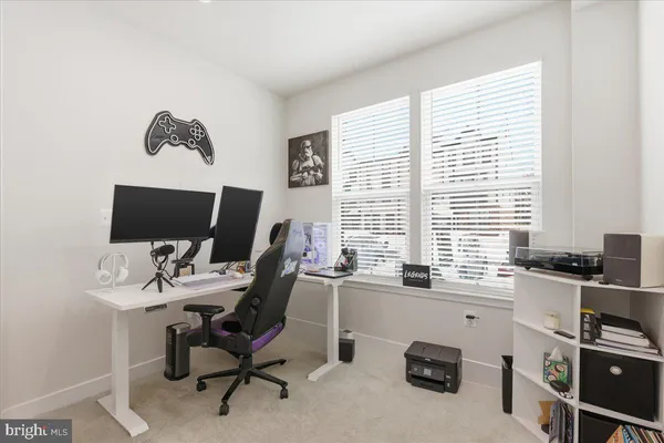 a view of a workspace with furniture and a window