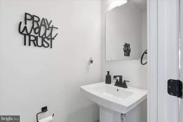 a white bathroom with a sink and mirror