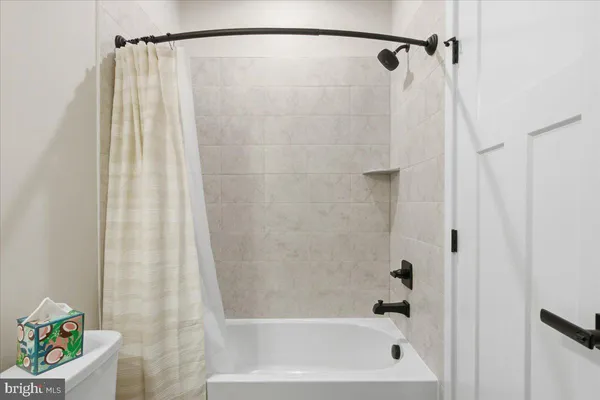 a bathroom with a shower and a bath tub