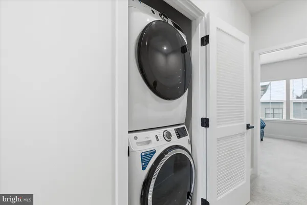 a view of a hallway with washer and dryer