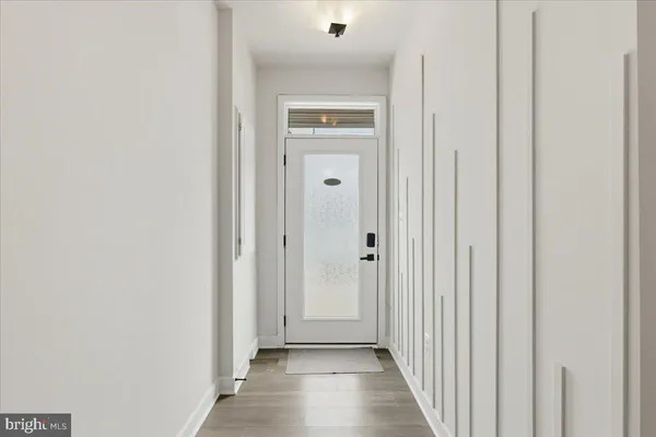 a view of a hallway with wooden floor