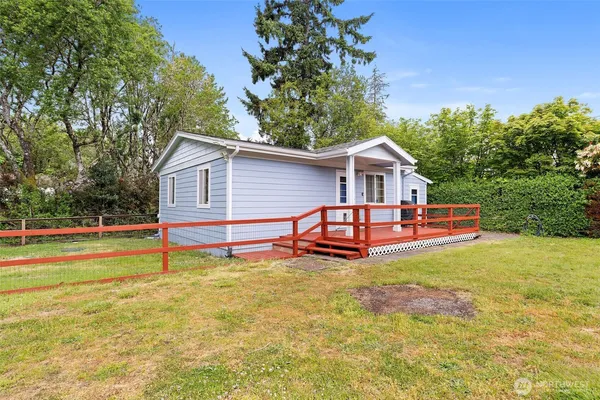 a view of a house with a yard patio and swimming pool